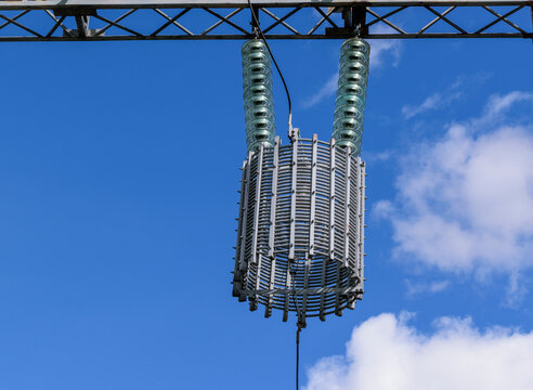 A line trap (high-frequency stopper) is a maintenance-free parallel resonant circuit. Metal constructions, high-voltage wires, glass insulators. 