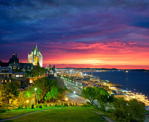 Naklejka premium Aerial view of the Quebec City skyline with the iconic Chateau Frontenac illuminated in foreground