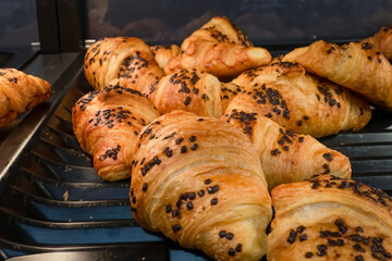 Freshly baked chocolate croissants in a bakery setting