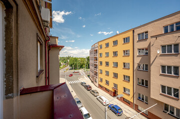 View from balcony, sunny day, clouds, wide angle real estate photo.