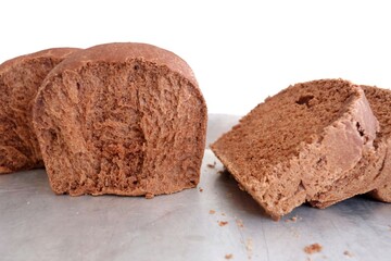 In selective focus a homemade chocolate bread slice on a food tray and kitchen white background 