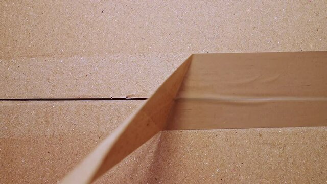 Unpacking cardboard box close up