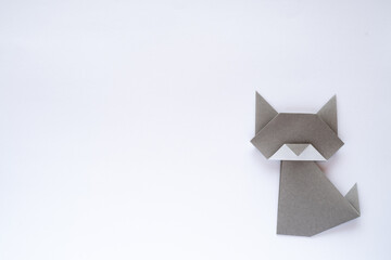 gray origami cat on white background