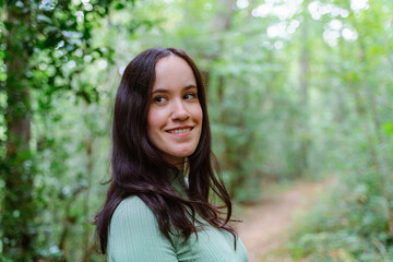 Horizontal view of brunette woman isolated on a meadow. Nature and ecology concept.