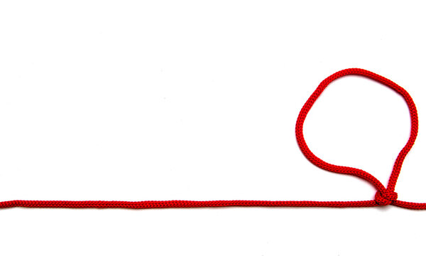 Red Twine With Knots On A White Background.