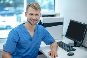 Young smiling male medic in the office © zinkevych