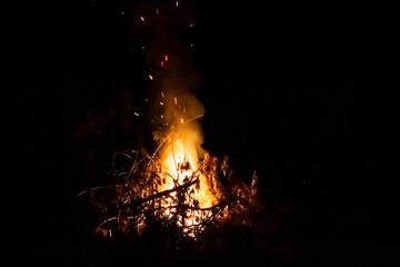 Fire on a dark background. Fire from firewood close up. Flaming burning sparks close-up, fire...