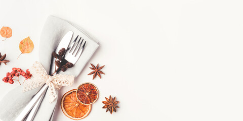 Thanksgiving autumn background. Plate with Cutlery and napkin decorated with autumn leaves, berries...