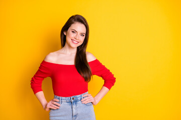 Photo of pretty adorable lovely young girl hands hips sides beaming smiling posing sister wedding holiday wear shirt open shoulders denim isolated vibrant yellow color background