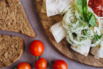 plate of fresh salads and mouth-watering ingredients for cooking, chili peppers, mini-tomatoes, grilled bread, blue onion