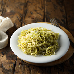Spaghetti with pesto sauce and cheese