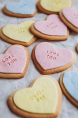 Valentine's Day presents: Heart-shaped cookies with colorful glaze and themed lettering for all lovers