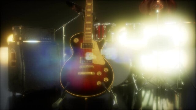 Drum kit and guitar in subdued stage lighting.