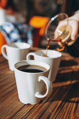 The coffee is alternatively made using a paper filter and a kemex is poured from the flask into a mug. Third wave cafe