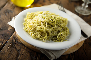 Spaghetti with pesto sauce and cheese