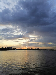 Fototapeta premium Beautiful sunset with the original clouds and the quiet water