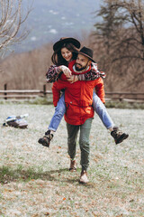 Naklejka na ściany i meble Loving couple walking on the mountain outdoors. Man and woman travel together. Couple traveler enjoys nature, hugs,