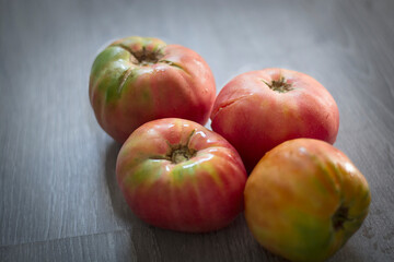 large tomatoes on top of wooden background