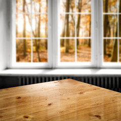 Fototapeta na wymiar Desk of free space and autumn window 