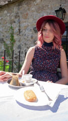 Caucasian woman enjoys coffee and Turkish sweets - Mostar, Bosnia and Herzegovina.