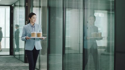 young asian trainee intern serving coffee to management team meeting in conference room in modern corporation