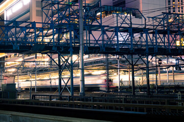 Light trail from moving train at Yokohama Station at night time. Long exposure landscape orientation.