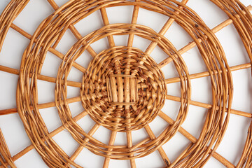 round wicker stand for pots on a white background