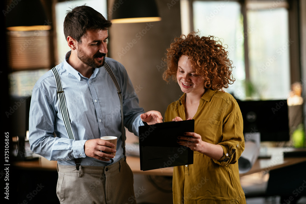 Wall mural businesswoman and businessman discussing work in office. two friends in working together.