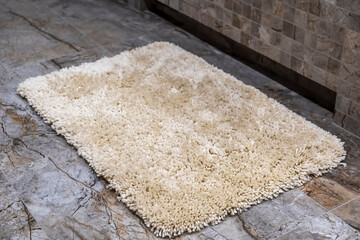 Beige mat in the bathroom