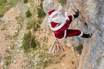 santa claus hanging on a rope in the forest