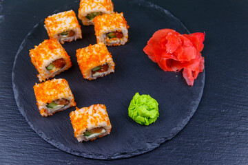 Sushi rolls Philadelphia on a black slate