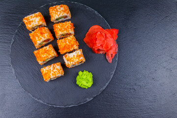 Sushi rolls Philadelphia on a black slate. Top view