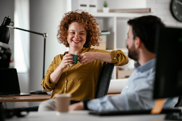 Colleagues in office. Businesswoman and businessman discussing work while drinking coffee...Colleagues in office. Businesswoman and businessman discussing work while drinking coffee...