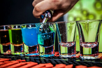 Barman preparing cold, tasty and colorful cocktails at the club 