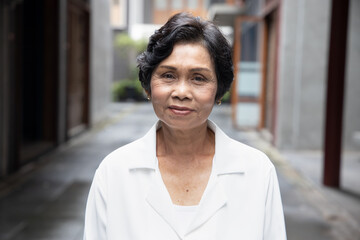 portrait of old Asian senior woman with wrinkle skin and black dyed hair