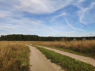 The road to the field and clouds