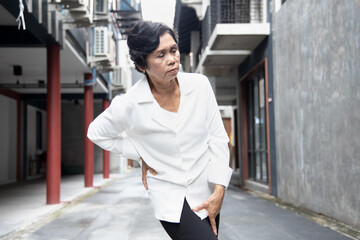 sick old asian senior woman suffering from pelvic pain, hip stiffness, gout, rheumatoid, osteoporosis