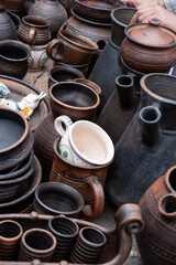Obraz na płótnie Canvas Handmade ceramic tableware. Reconstruction of an ancient craft. Plates, mugs, clay pots.