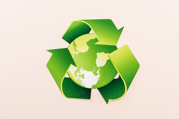 top view of green recycling symbol with planet isolated on beige