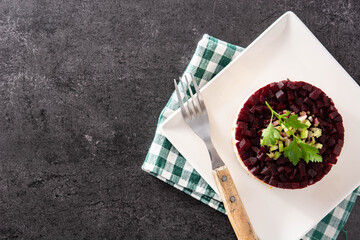 Traditional Russian herring salad with beetroot and carrots. Top view. Copy space