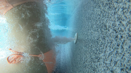 Woman in bikini Underwater massage with jets in hot tub spa with bubbles. female relax in the pool.