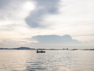 seascape with fishing boat and mussel farm in sunset. panorama sea view at dawn. copy space.