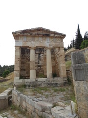 Ruined ancient sanctuary Delphi, also called Python, in Greece in summer. The?ancient Greeks?considered the centre of the world to be in Delphi, marked by the stone monument known as?the omphalos.
