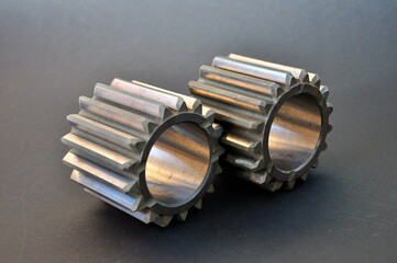 cogwheels together on dark surface