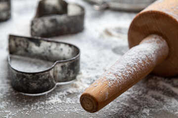 Antiques metal forms for Christmas cookies on the table with flour. Holiday cooking background