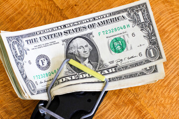 American dollars caught in a mouse trap.