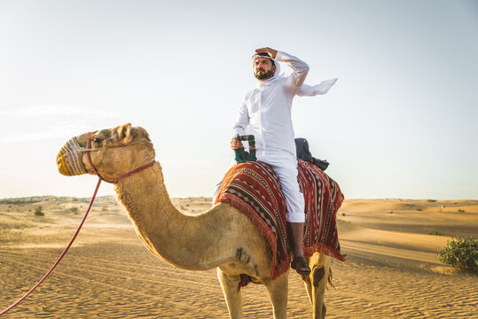 Arabian Man With Camel In The Desert