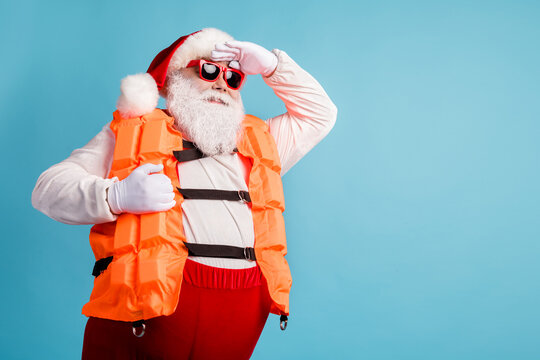 Profile side view portrait of his he cheerful confident white-haired Santa seaman swimmer instructor wearing safe vest looking far away isolated bright vivid shine vibrant blue color background