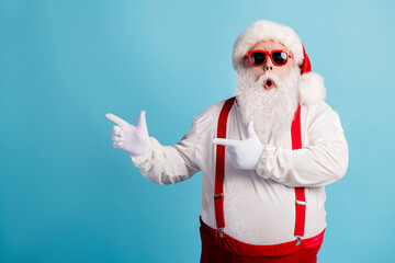 Fototapeta na wymiar Portrait of his he nice attractive amazed wondered overweight white-haired Santa demonstrating copy space solution advice attention isolated over bright vivid shine vibrant blue color background