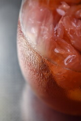 iced tea with grape fruits silver back ground 